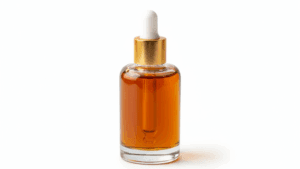 30ml round Boston glass bottle with gold dropper cap filled with amber-colored saffron extract on pure white background"