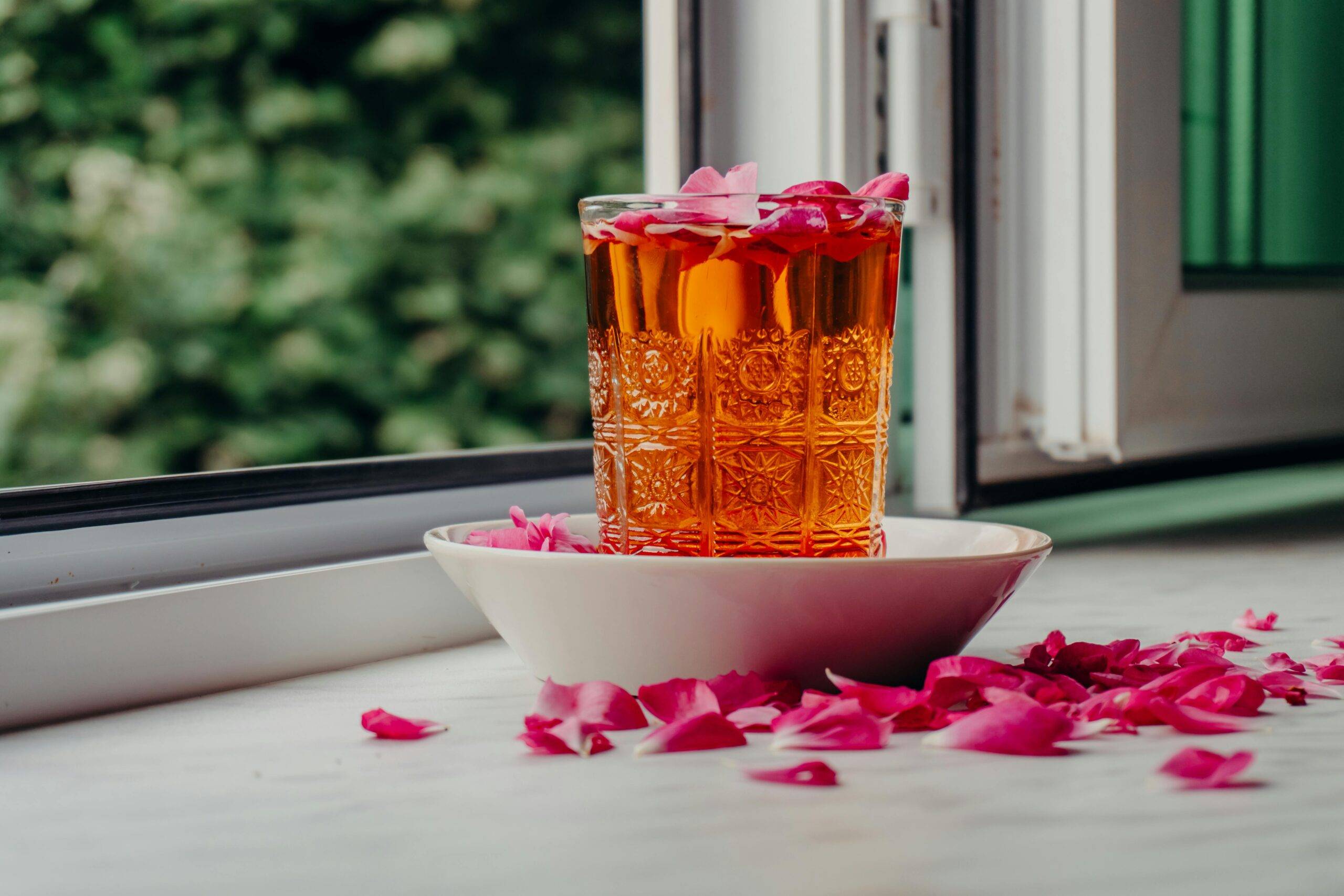 Elegant rose infused beverage by window